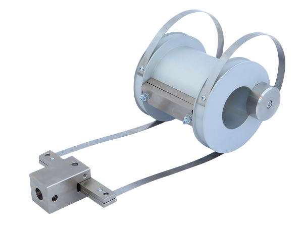 Climbing drum peel test fixture with an aluminum drum, guiding side arms, and a metal clamping block used to measure adhesive bond strength during controlled peeling.