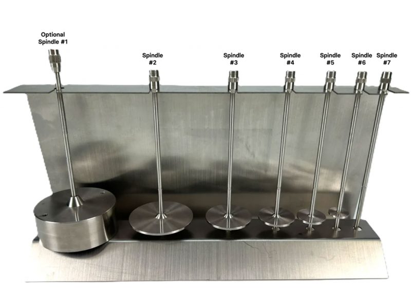 Set of seven stainless steel spindles for a viscometer, arranged on a metal stand and labeled from spindle #1 to spindle #7.